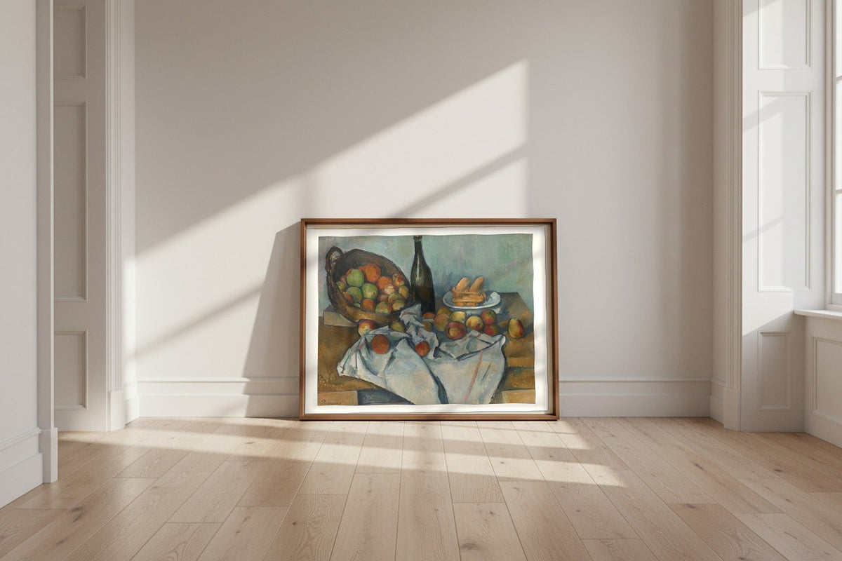 The Basket of Apples — Paul Cézanne Fine Art Poster shown framed and leaning against a wall in a sunlit room