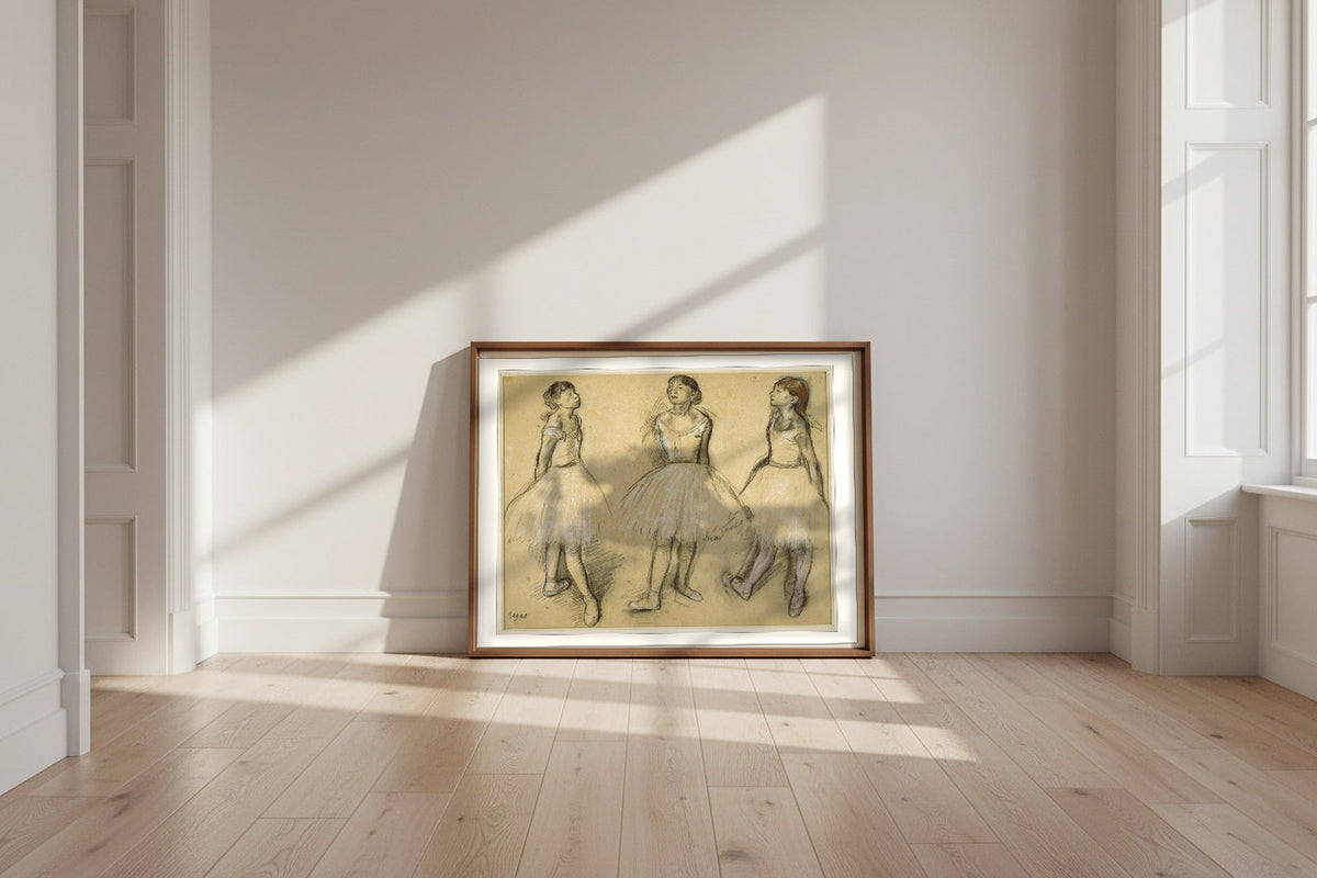 Three Studies of a Dancer in Fourth Position — Edgar Degas Fine Art Poster shown framed and leaning against a wall in a sunlit room