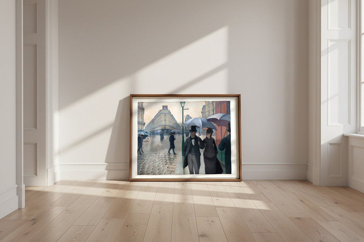 Paris Street; Rainy Day — Gustave Caillebotte Fine Art Poster shown framed and leaning against a wall in a sunlit room