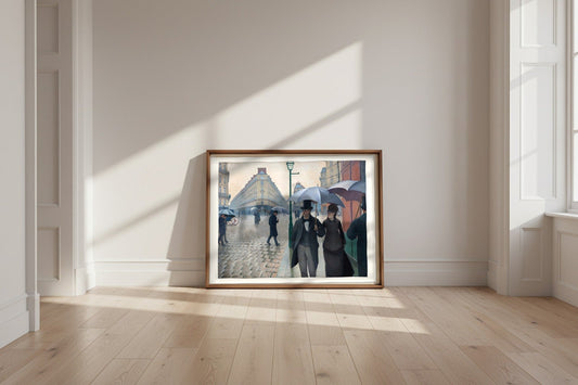 Paris Street; Rainy Day — Gustave Caillebotte Fine Art Poster shown framed and leaning against a wall in a sunlit room