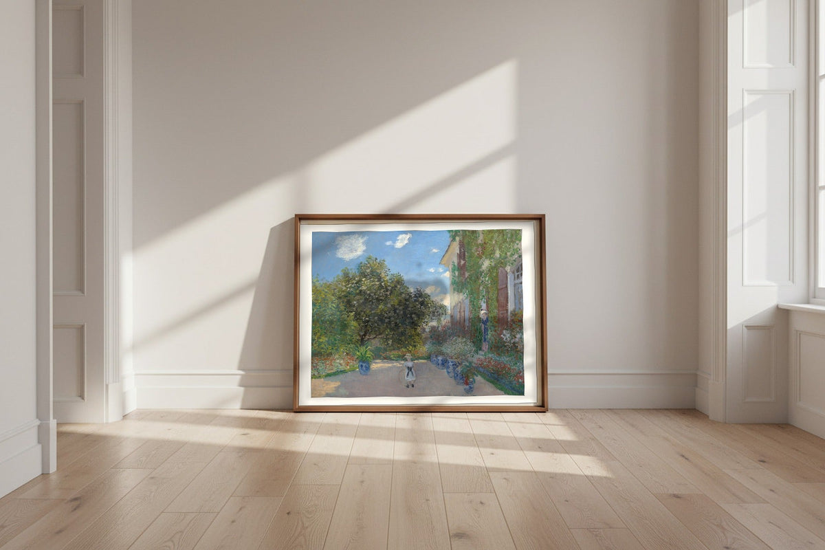 The Artist's House at Argenteuil — Claude Monet Fine Art Poster shown framed and leaning against a wall in a sunlit room