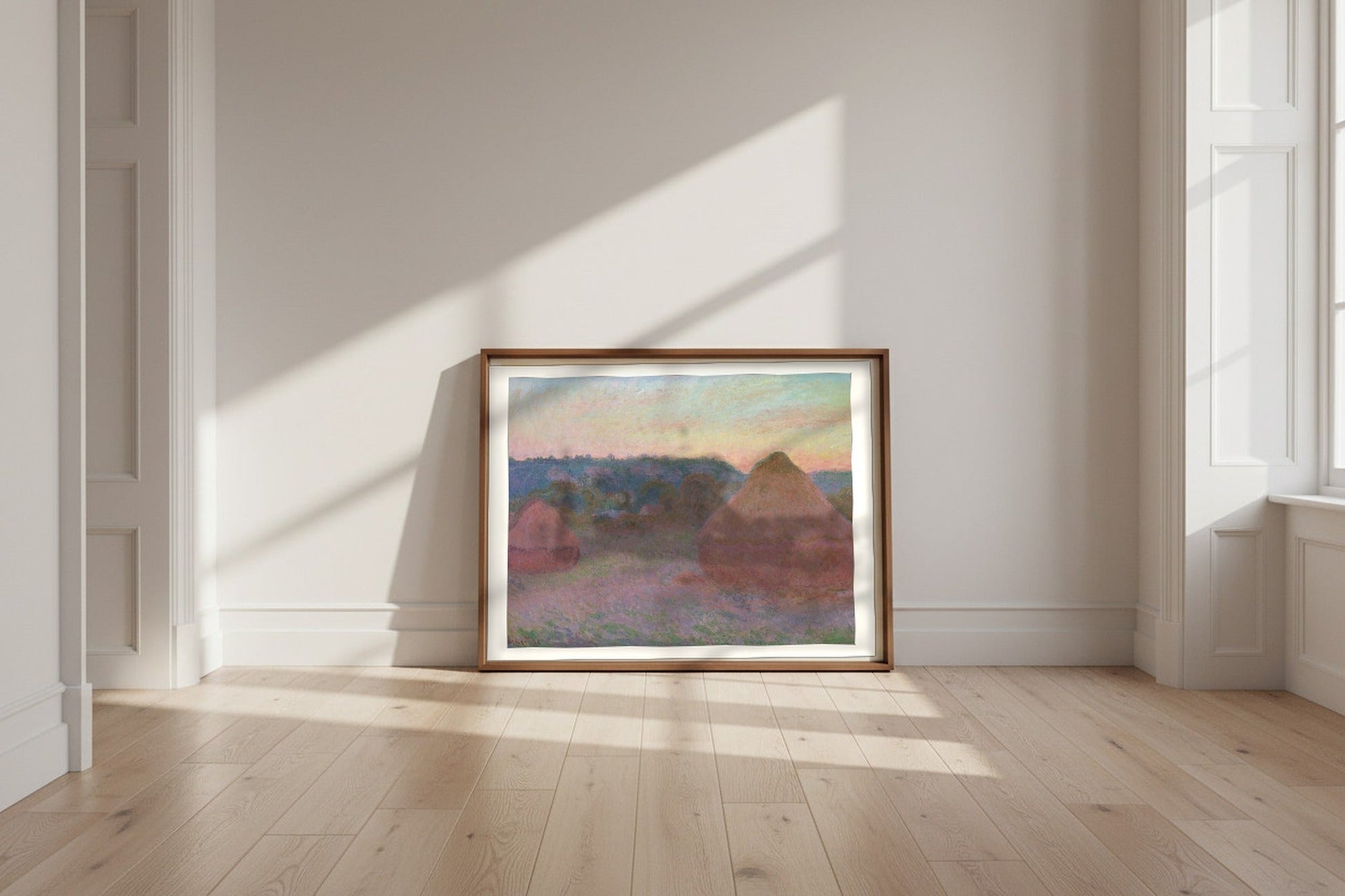 Stacks of Wheat (End of Day, Autumn) — Claude Monet Fine Art Poster shown framed and leaning against a wall in a sunlit room