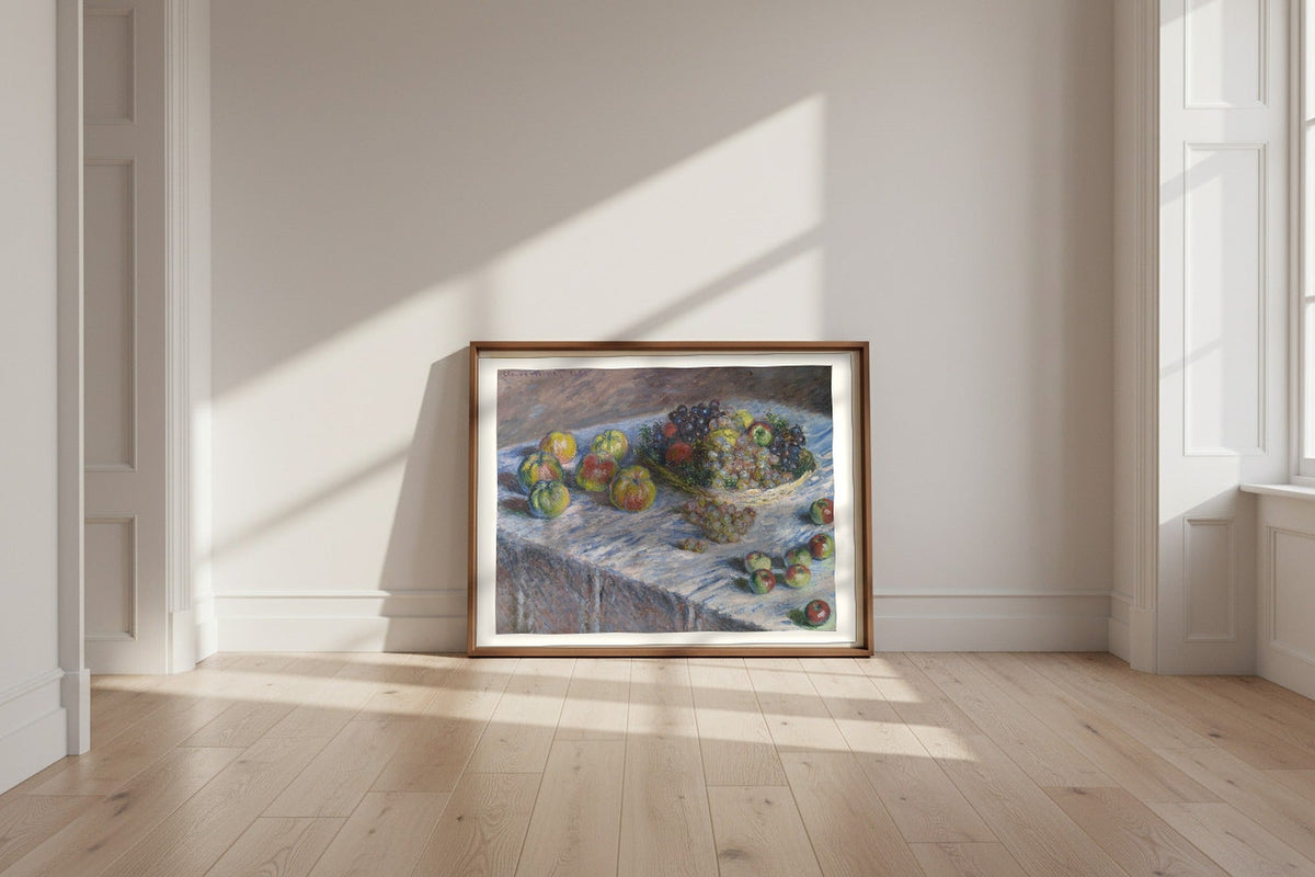 Apples and Grapes — Claude Monet Fine Art Poster shown framed and leaning against a wall in a sunlit room