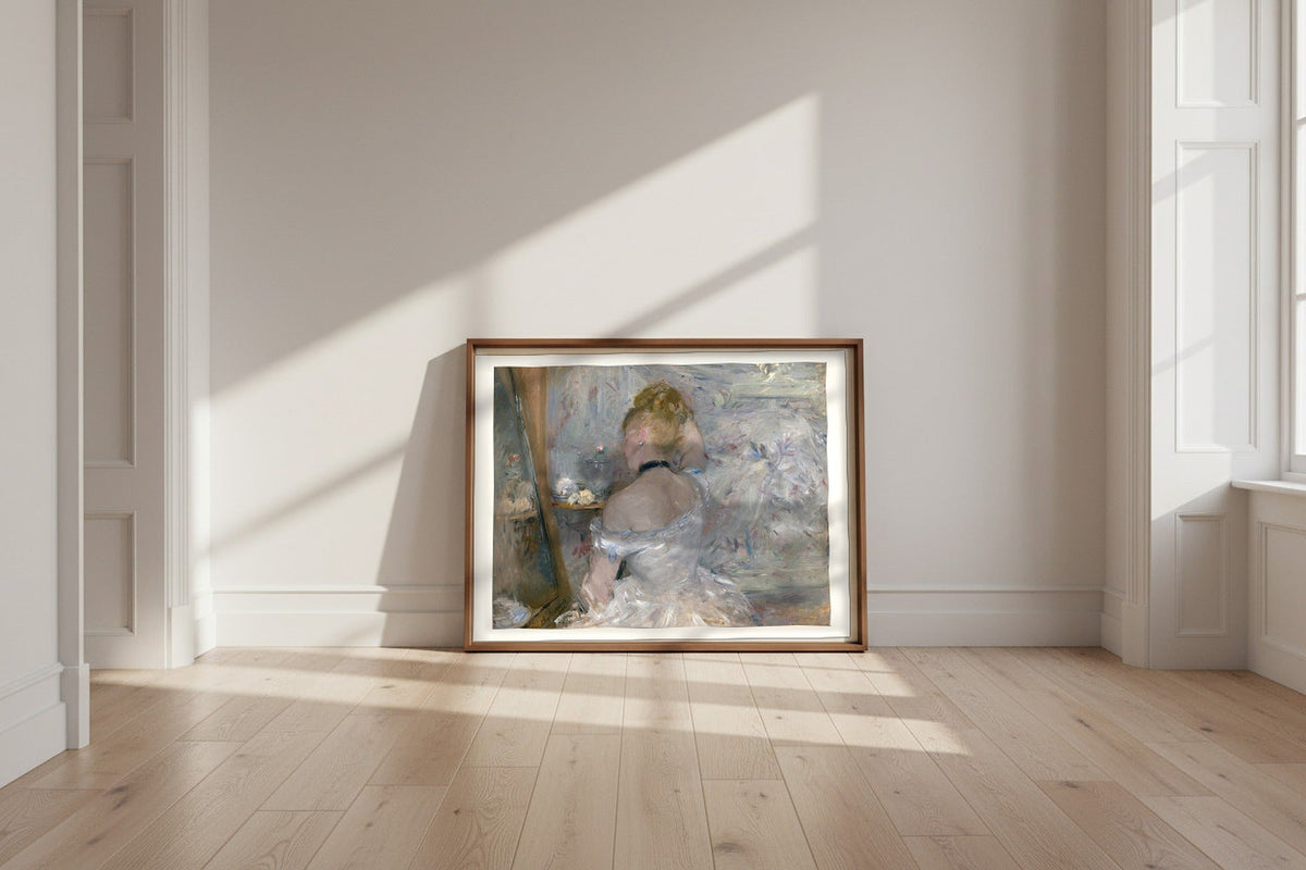 Woman at Her Toilette — Berthe Morisot Fine Art Poster shown framed and leaning against a wall in a sunlit room