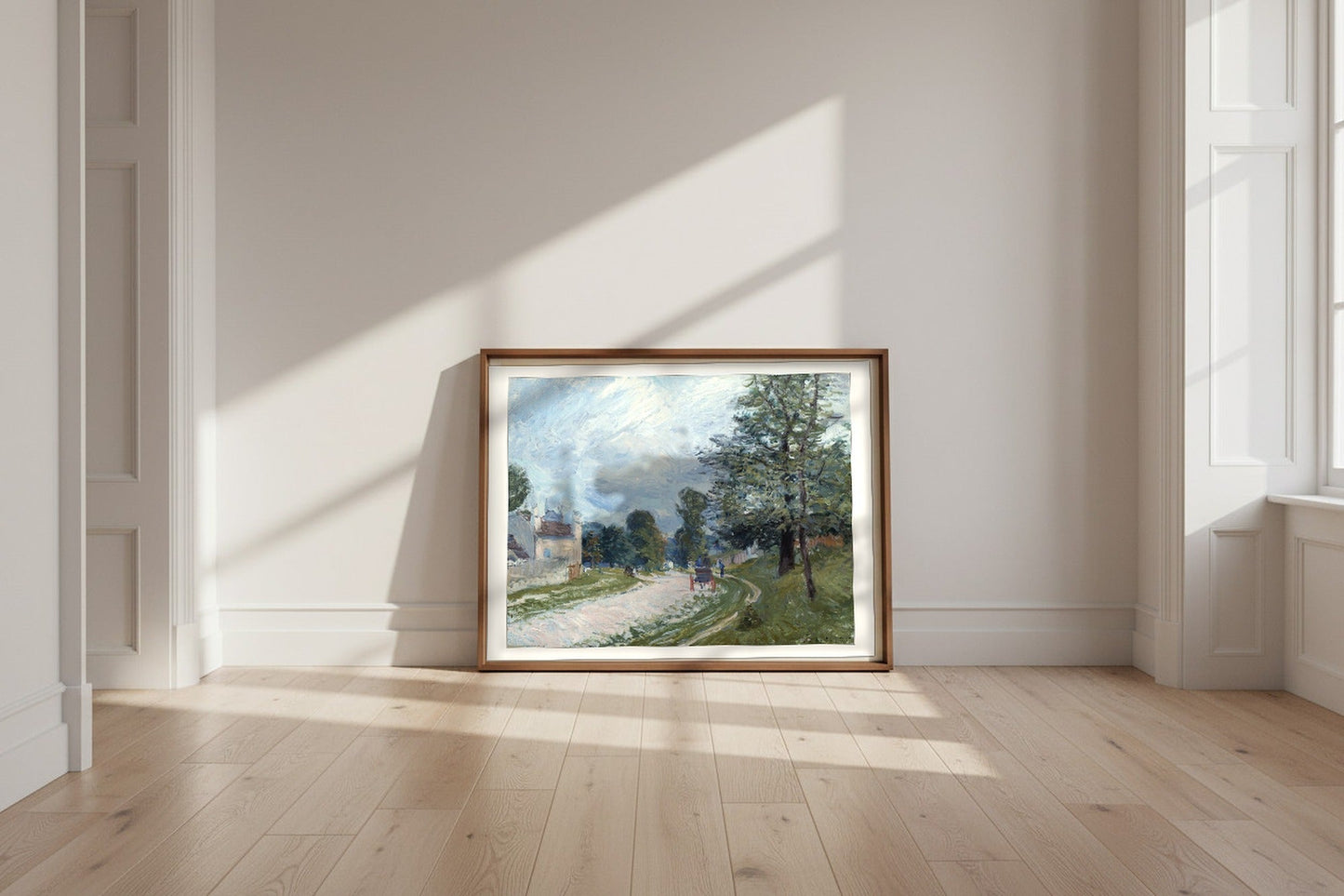 A Turn in the Road — Alfred Sisley Fine Art Poster shown framed and leaning against a wall in a sunlit room