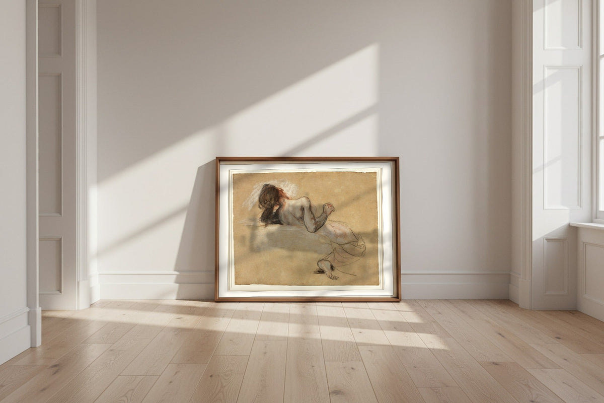 Crouching Woman — Eugène Delacroix Fine Art Poster shown framed and leaning against a wall in a sunlit room