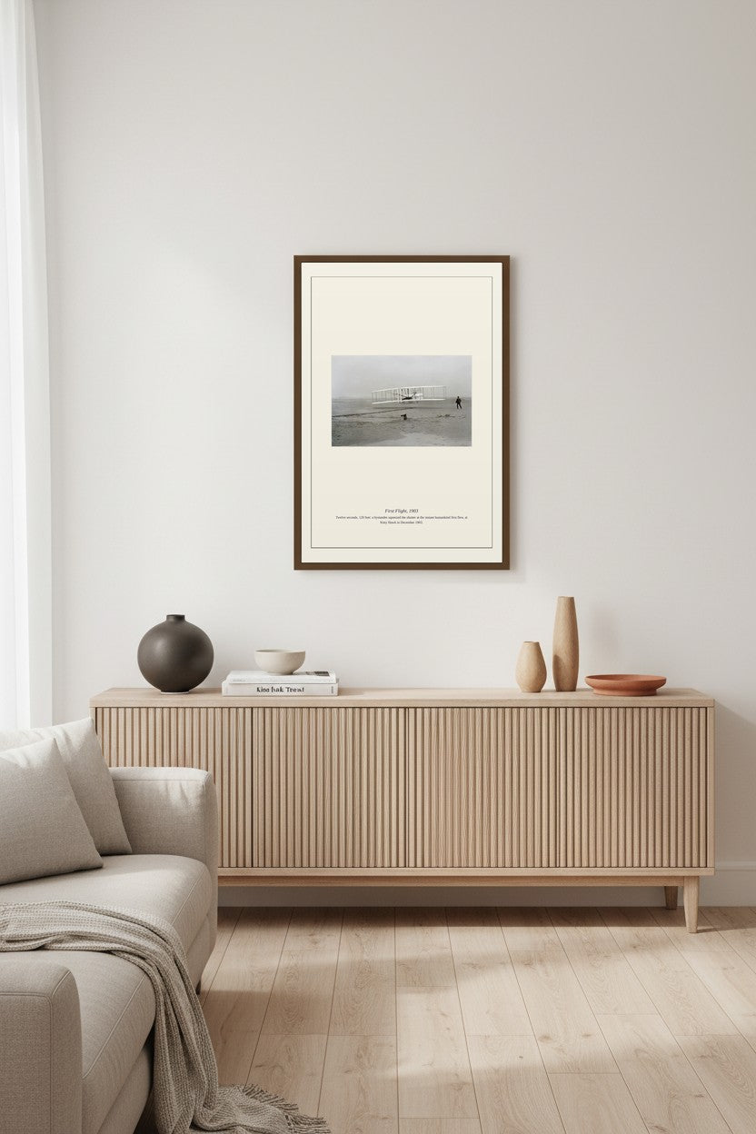 First Flight photograph in a wood frame above a ribbed light sideboard