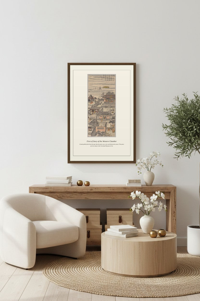 First of Story of the Western Chamber print framed above a round wood table beside a white armchair