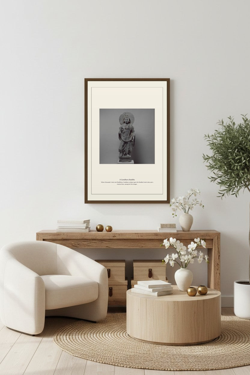 Gandhara Buddha sculpture print above a console table in a neutral entryway