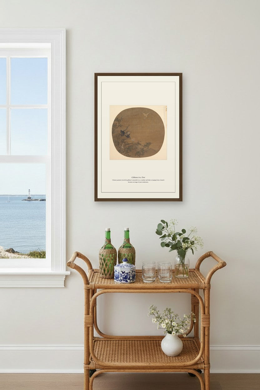 Gibbons in a Tree fan painting framed above a rattan bar cart near an ocean-view window