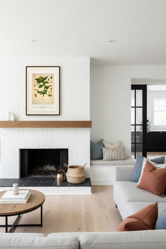Henbane print in a wood frame beside a cream armchair and console table