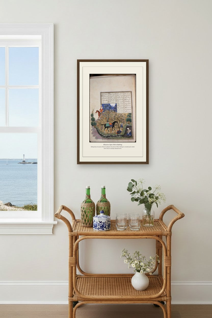 Khusraw Spies Shirin Bathing manuscript framed above a rattan bar cart near an ocean-view window