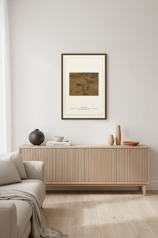 Lotus and Ducks painting framed above a ribbed wood sideboard in a minimalist living room