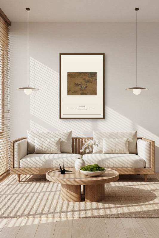 Framed Lotus and Ducks print above a sunlit sofa with pendant lights and a round coffee table