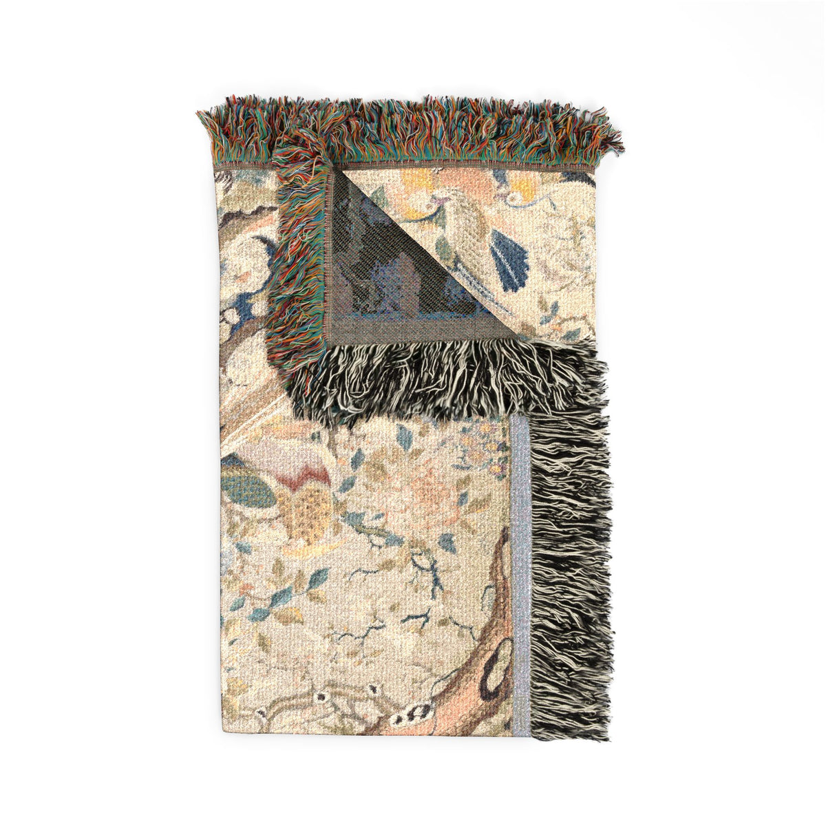 Myriad of Birds blanket corner folded, front with birds and flowers and dark reverse corner, fringe visible