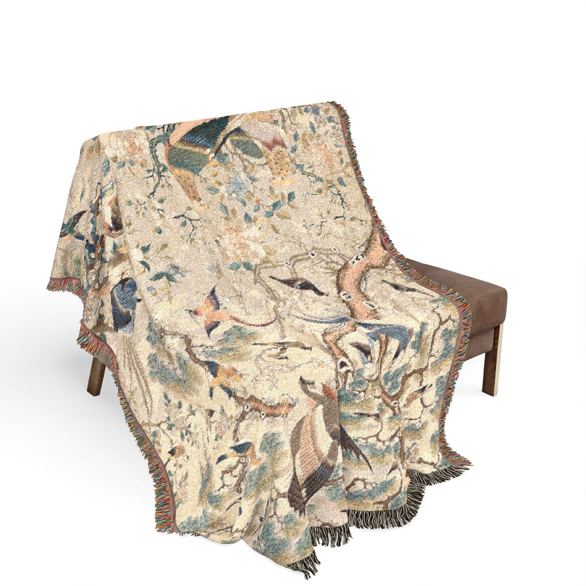 Myriad of Birds blanket draped over bench, cream bird-and-branch pattern with lavender border, fringe hanging