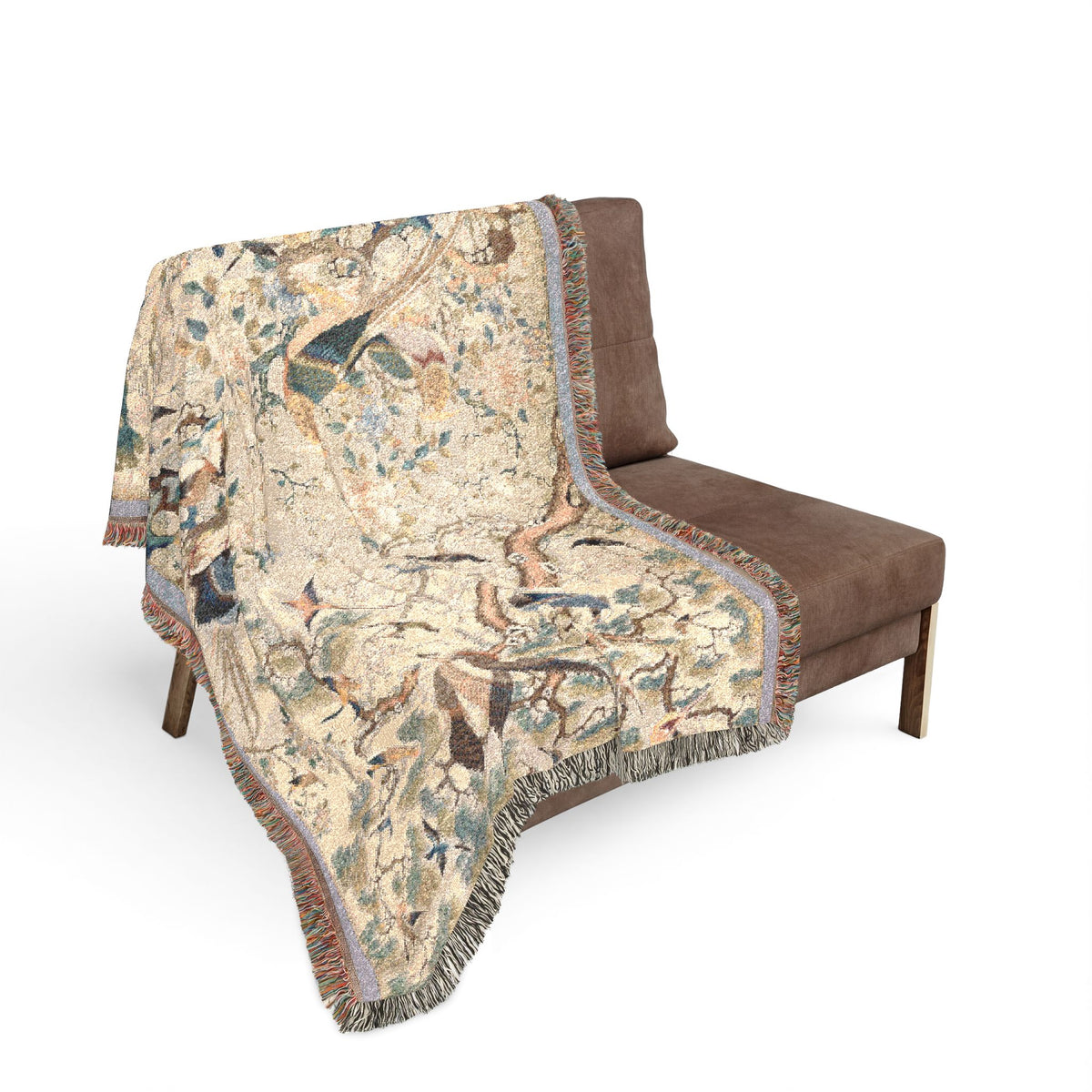 Myriad of Birds blanket draped over sofa, cream bird pattern with lavender border fringe draping over edges