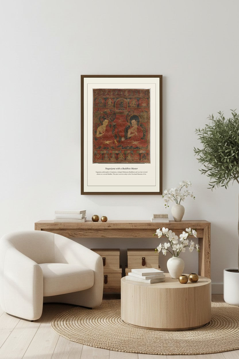 Nagarjuna with a Buddhist Master thangka framed above a light wood console with an armchair and coffee table