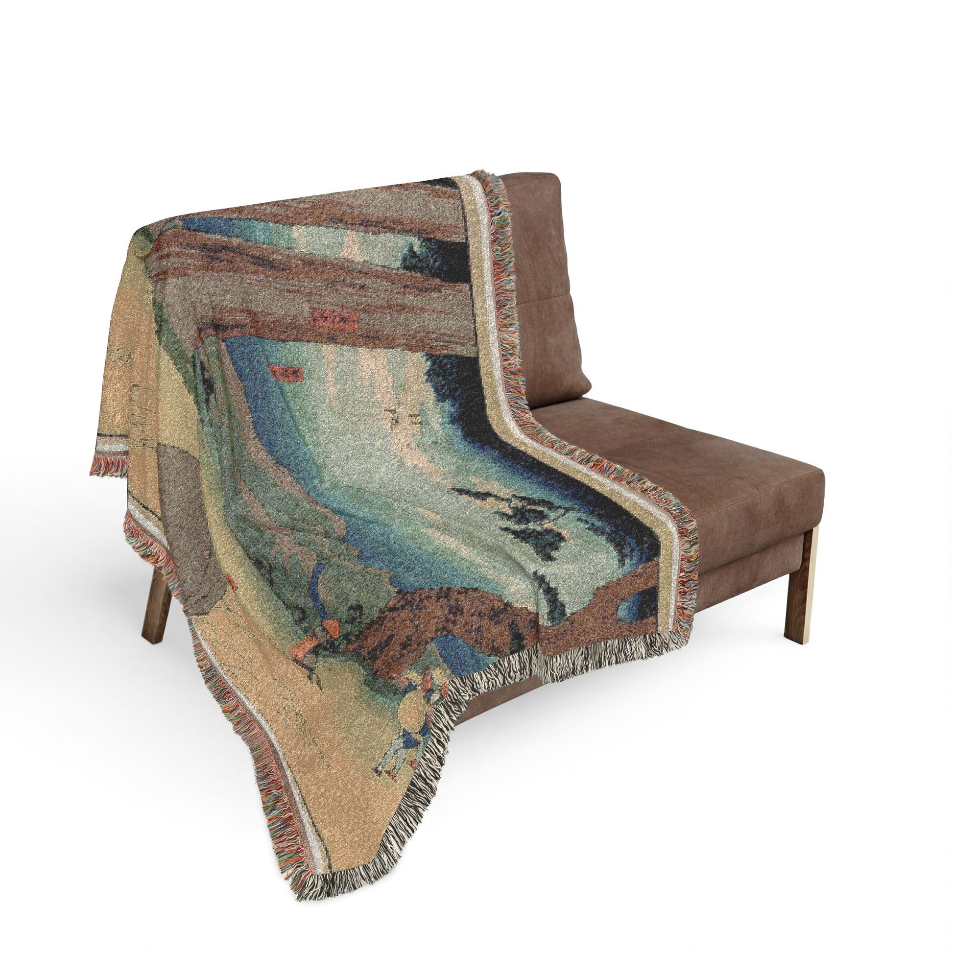 Nissaka Night-Weeping Stone throw blanket draped over sofa, woodblock landscape with blue sky zone and tiny figures, fringe