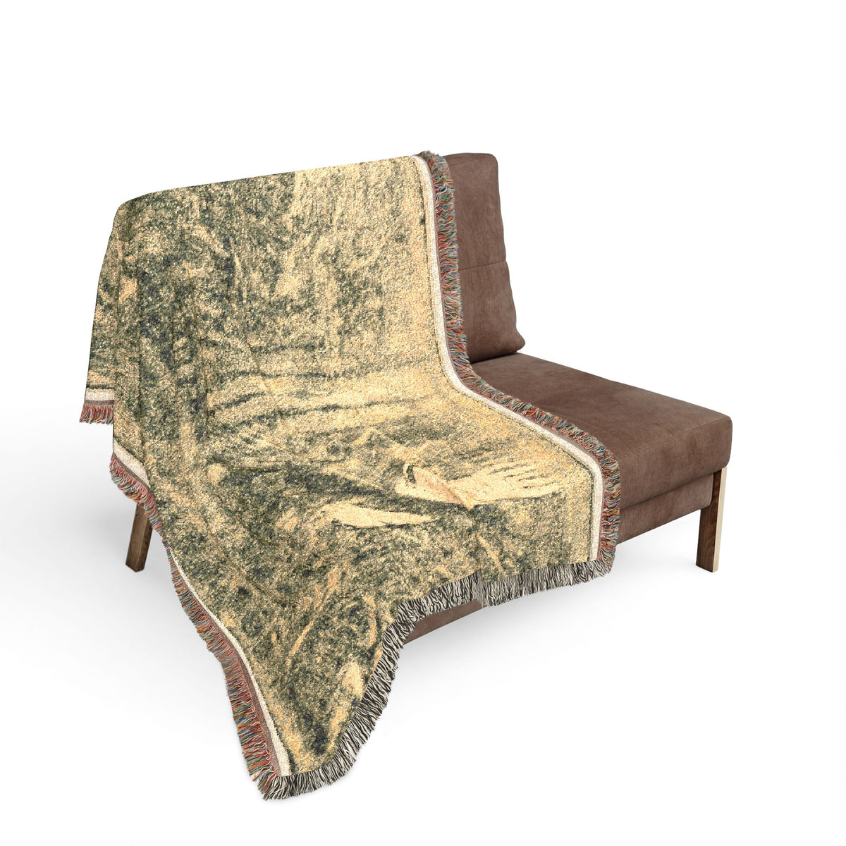 Noa Noa Woven Throw Blanket sofa drape, dark Gauguin forest motif across brown sofa back, fringe edge