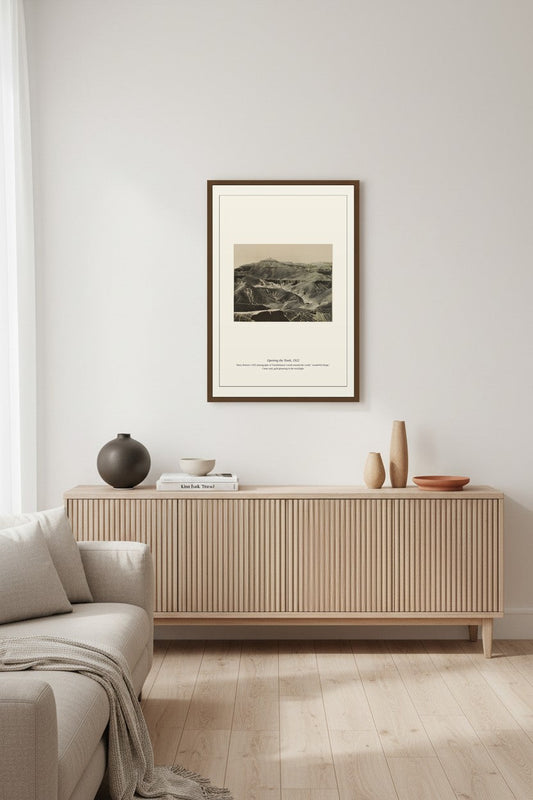 Opening the Tomb photograph framed above a ribbed wood sideboard in a minimalist living room