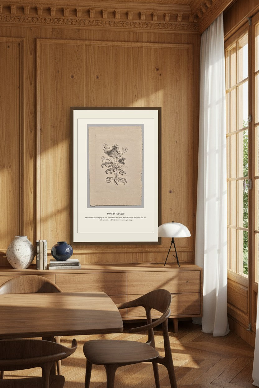 A framed botanical art print featuring a bird illustration on aged beige paper, displayed on a wooden wall in a warm, sunlit dining room with wood paneling, chairs, and a window.