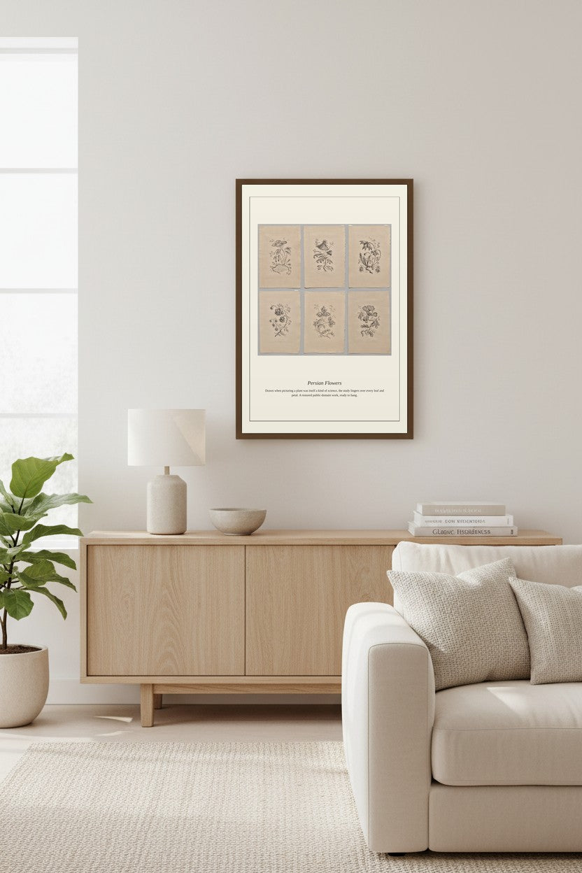 A framed botanical art print with six beige panels and delicate dark line drawings, displayed on a light gray wall above a light wood sideboard in a modern living room setting.