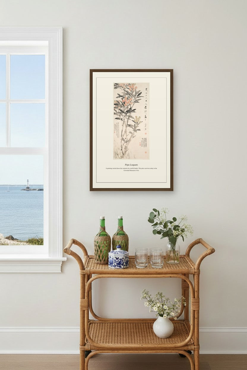 Framed Pipa Loquats painting above a rattan bar cart near a coastal window