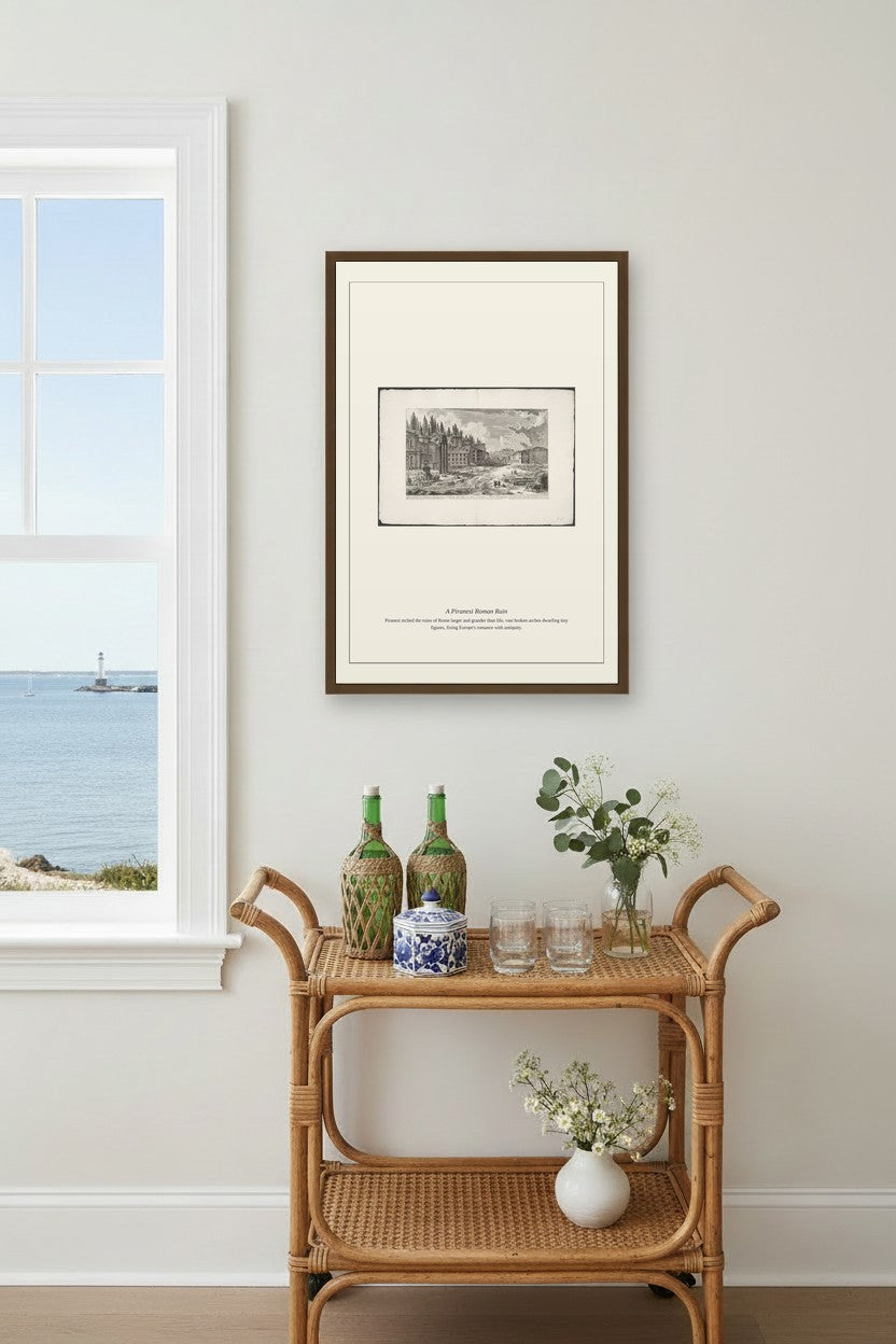 A Piranesi Roman Ruin framed above a light wood sideboard beside a curtained window