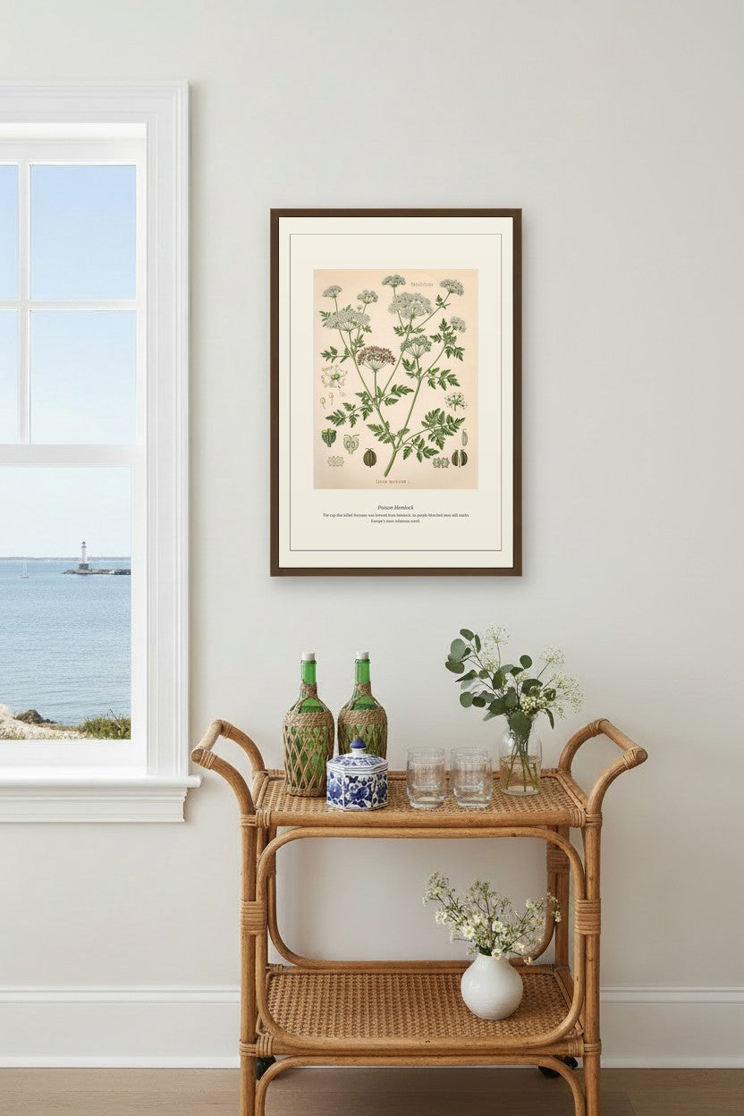 Poison Hemlock print above a rattan bar cart near a window overlooking the sea