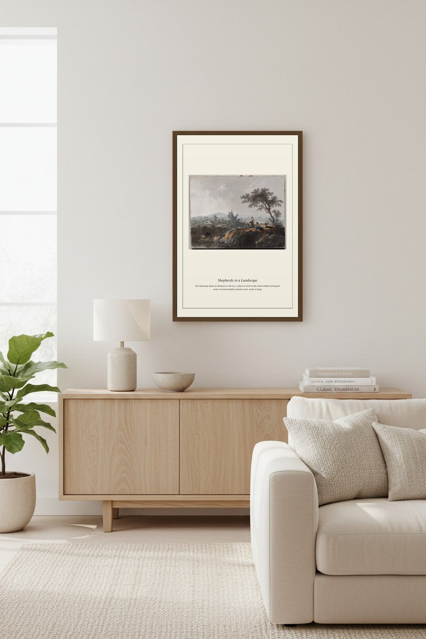 A framed art print featuring a classical landscape painting is displayed on a light gray wall above a modern light wood sideboard in a bright, minimalist living room.
