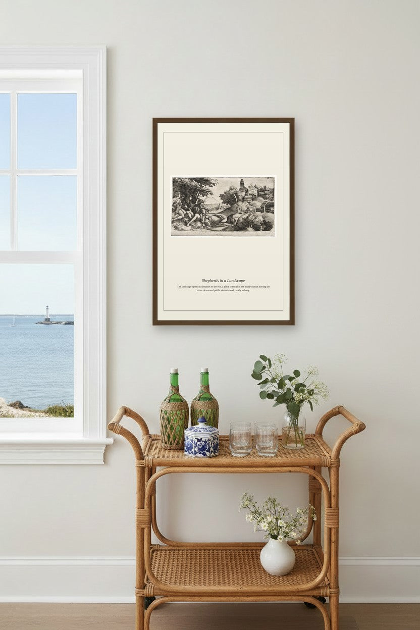 A framed black and white landscape art print hangs on a light gray wall above a rattan bar cart with decorative bottles and flowers, next to a window showing the ocean.