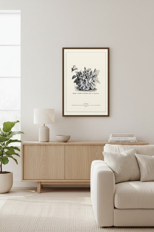Sweet Basil botanical print framed above a console table with a fiddle-leaf fig and stacked books