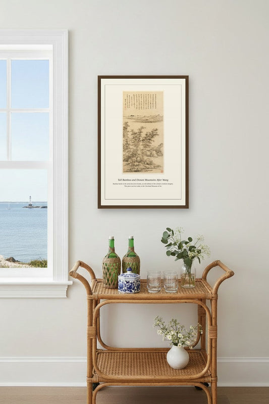 Framed bamboo landscape print above a rattan bar cart near a coastal window