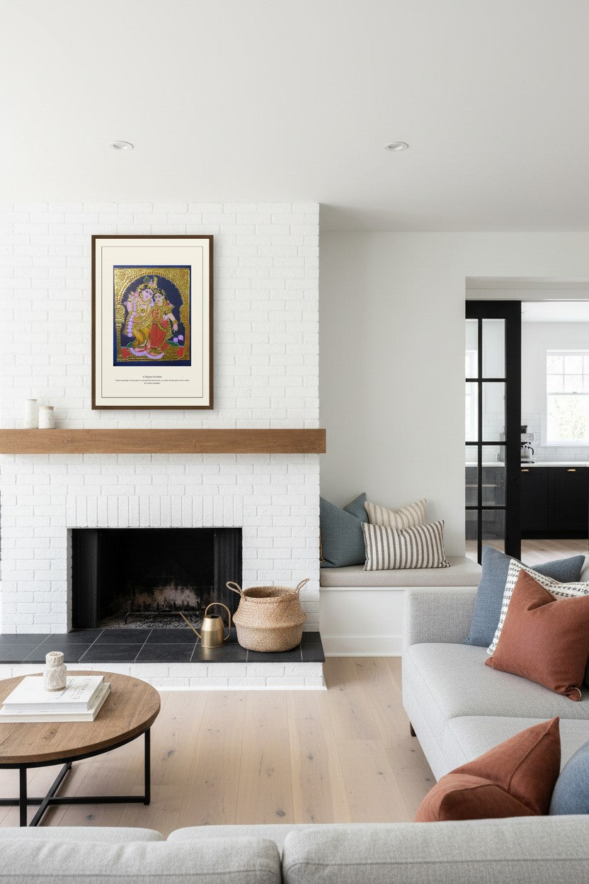 A Tanjore Krishna gold painting print framed above a white fireplace mantel