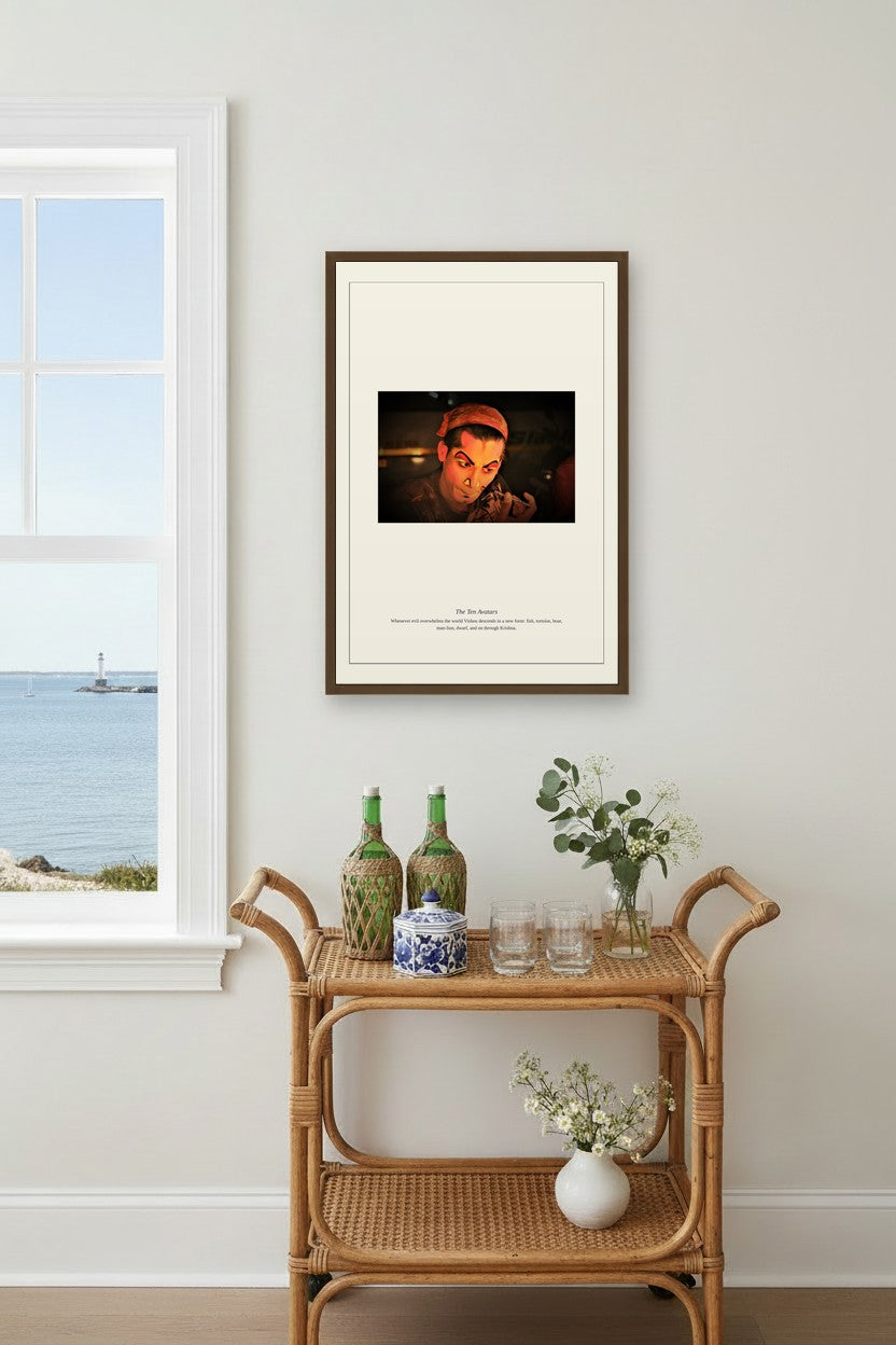 The Ten Avatars print framed above a rattan bar cart near a window with a coastal view