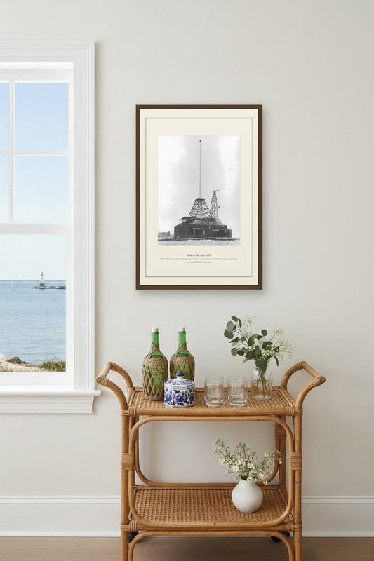 Tesla laboratory tower photo framed above a rattan bar cart by the sea