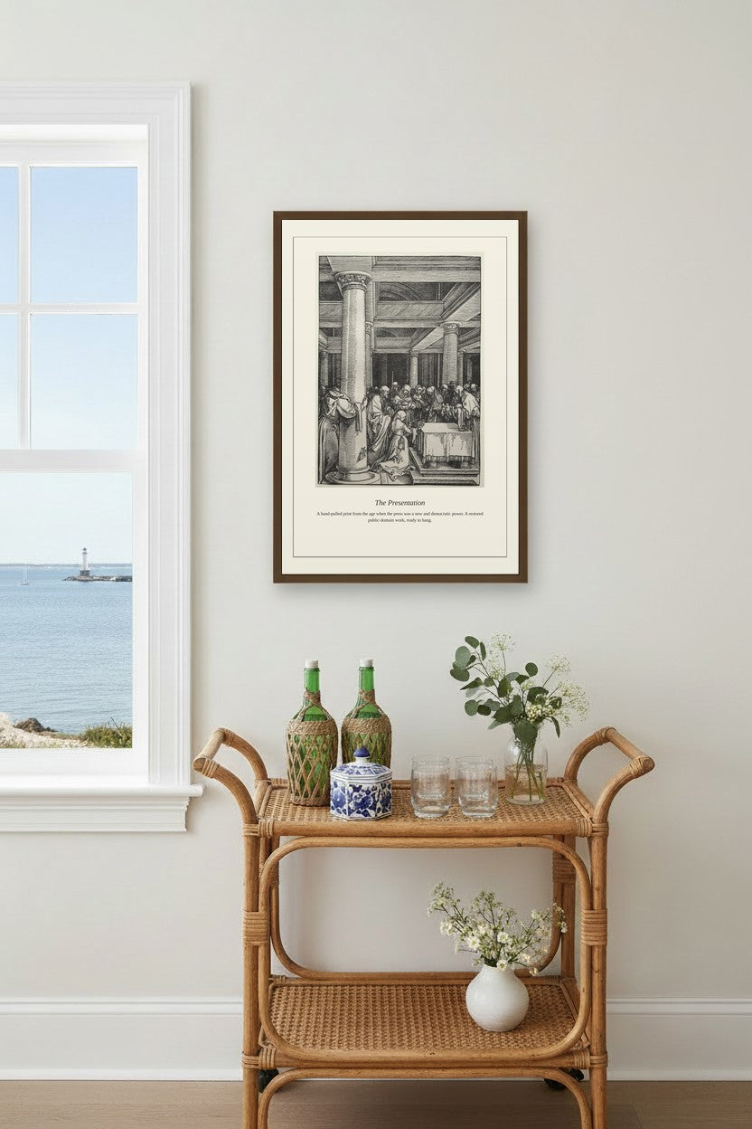A framed black and white art print of 'The Restaurant' hangs on a light gray wall in a styled room setting above a rattan bar cart with decorative bottles and flowers.