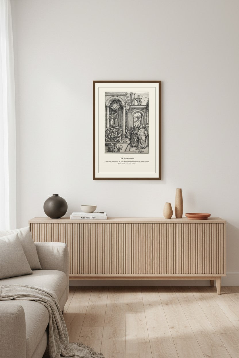 A framed black and white art print titled 'The Restaurant' is displayed on a light gray wall above a light wood sideboard in a modern, minimalist living room setting.