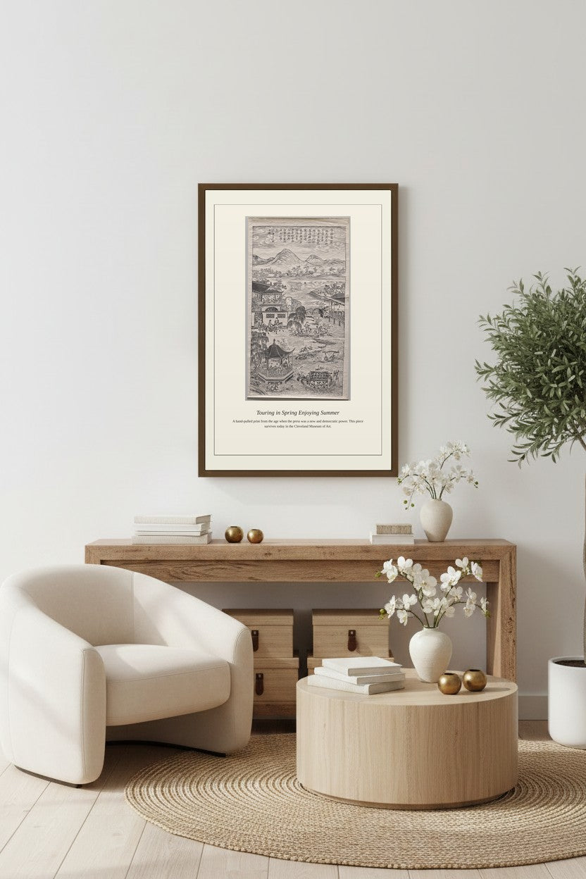 Framed Touring in Spring Enjoying Summer print above a wooden sideboard beside a white armchair