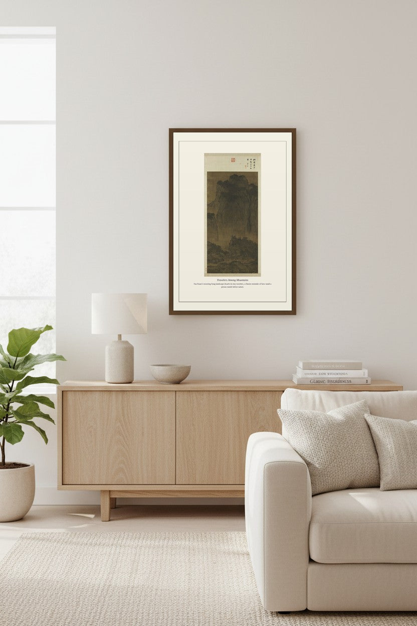 Travelers Among Mountains landscape print above a light wood sideboard and sofa