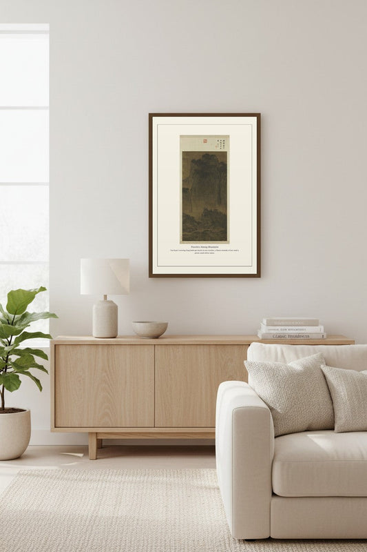 Travelers Among Mountains landscape print above a light wood sideboard and sofa