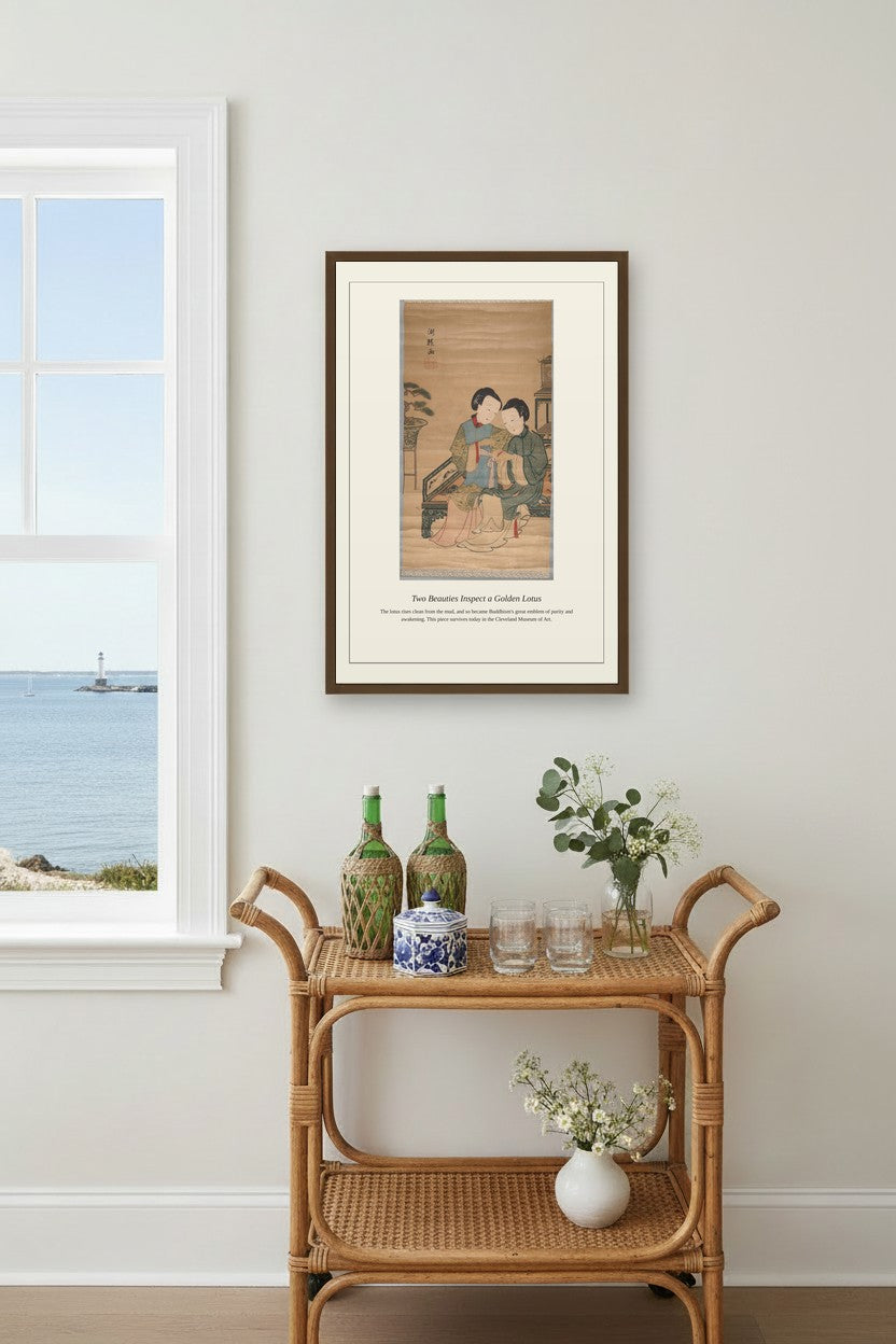 Two Beauties Inspect a Golden Lotus print framed above a beige sofa between wall sconces