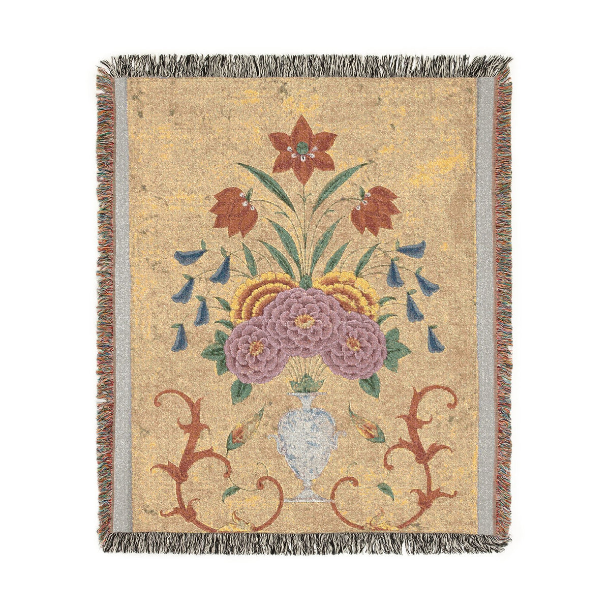 Vase with flower arrangement woven throw blanket flat lay, sandy gold ground with purple blooms and red scrollwork
