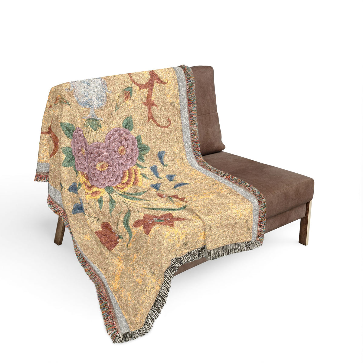 Vase with flower arrangement woven throw blanket over sofa back, gold ground with purple roses and red scrollwork